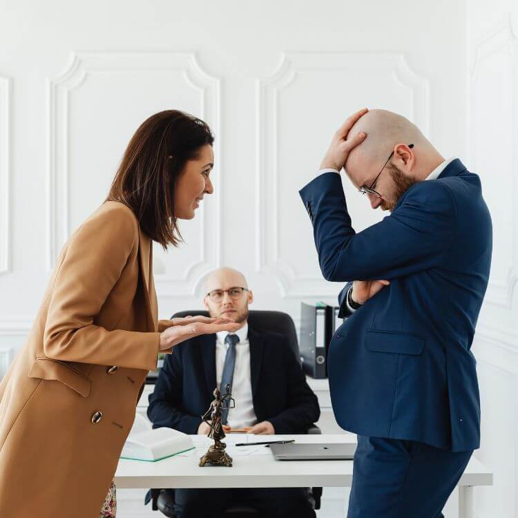 A couple argues in front of a mediator, which is a common occurance during family transitions.
