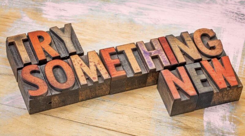 "Try something new" in wooden letters that resemeble a stamp to signify this article is about trying something new quotes.