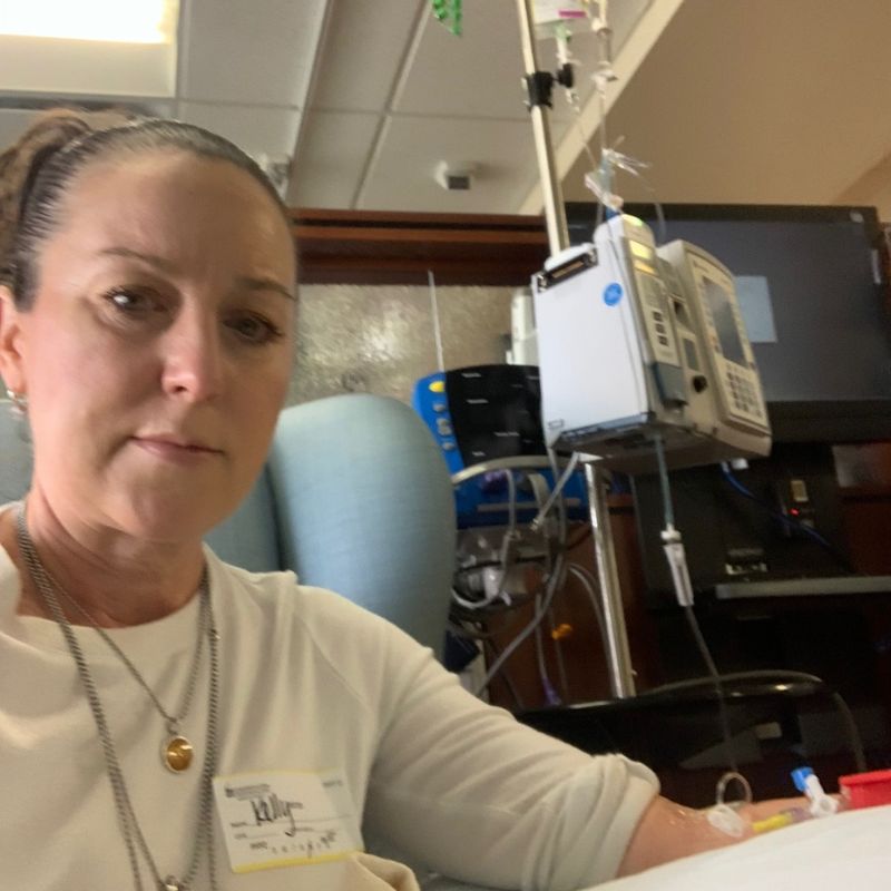 A photo of Kelly Hall receiving treatment for her illness, which was a turning point in redefining health as she knew it.