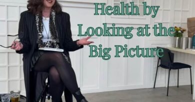 A photo of the author presenting to a room about we need to redefine health and look at the bigger picture.