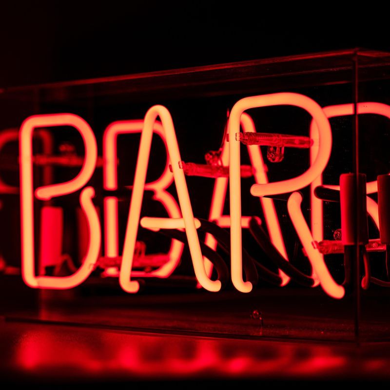 A neon light "Bar" sign.