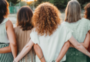 A group of women link hands behind their back. It symbolizes Clementine's lifelong mission of understanding what finding community means.