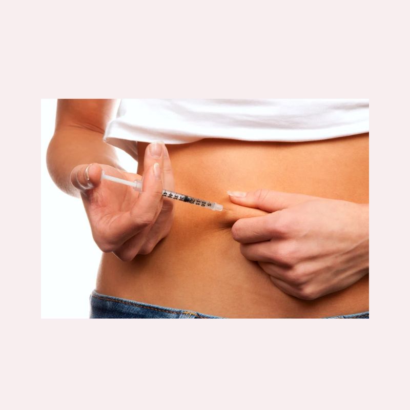 A woman injecting herself with fertility drugs.